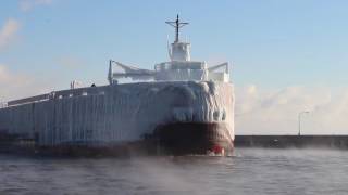 Icecoated ship enters Duluth canal [upl. by Ahsikan]